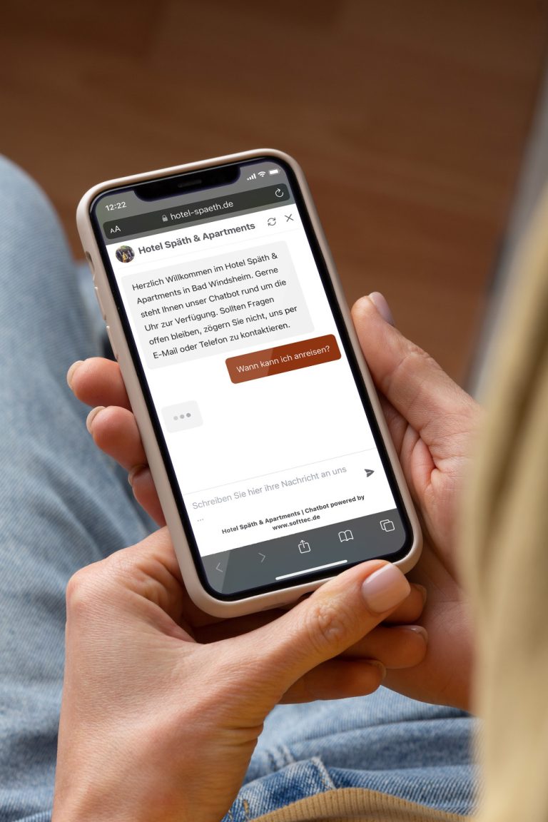 SoftTec Chatbot Mockup Hochformat Haende mit Smartphone 768x1152
