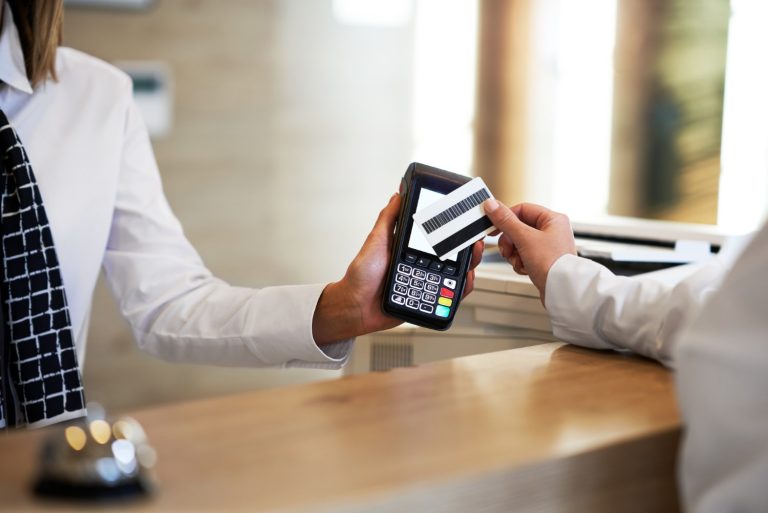 receptionist and businesswoman at hotel front desk 1 768x513